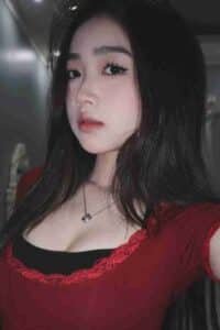 KL Escort Girl Attractive Asian woman with long black hair wearing a red top and a necklace. Sex Call Girl