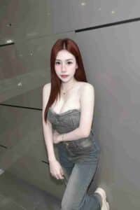 KL Escort Girl Woman with long red hair wearing a denim top and jeans. Sex Call Girl