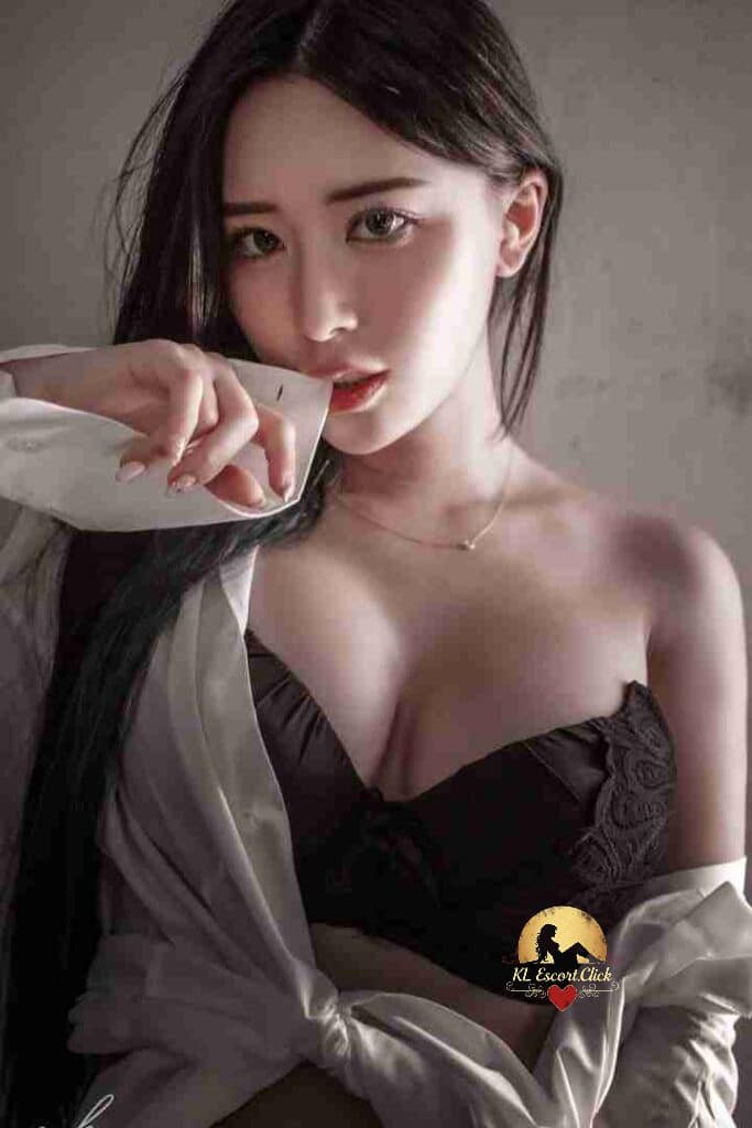 Beautiful Asian woman in black bra and white shirt looking at camera with red lipstick.