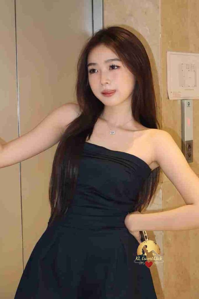 Attractive Asian woman in strapless black dress, wearing necklace. Party incall/outcall.