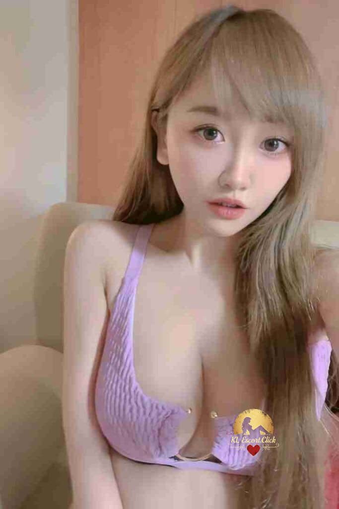 Attractive Asian woman with blonde hair and purple top.