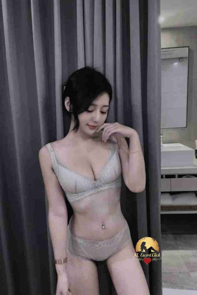 Attractive Asian woman in lingerie. Soft lighting, bathroom background. Chic and alluring pose.