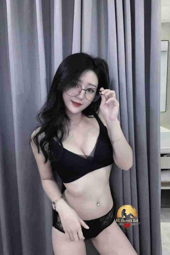 Attractive Asian woman in lingerie and glasses posing confidently.