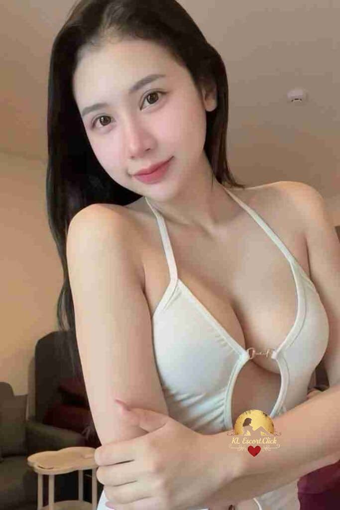 Beautiful Asian woman in white halter top smiling at camera. Portrait of a pretty young girl.