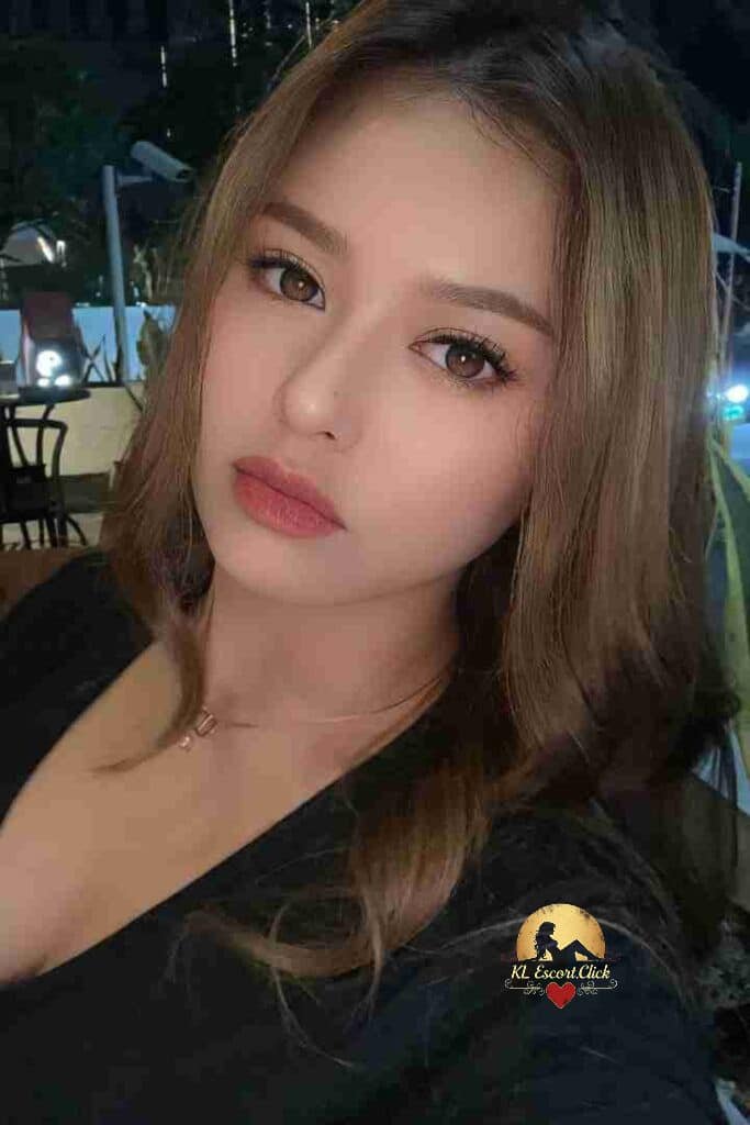 KL Escort Girl Smiling Asian woman in black tank top with soft, wavy hair, looking to the side. Sex Call Girl