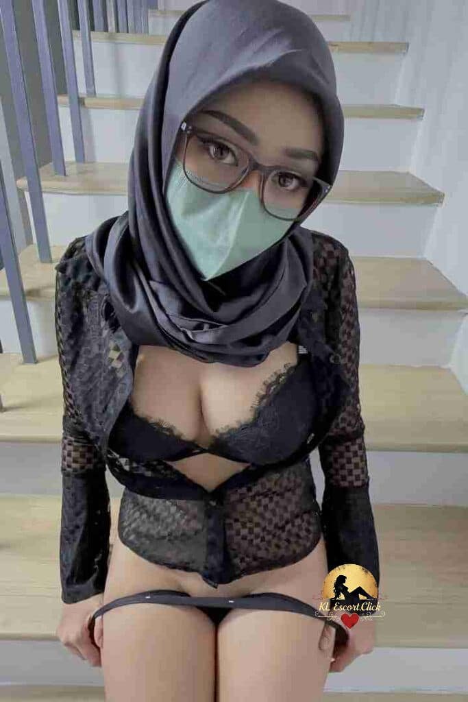 Aila, Malay woman in hijab, lingerie, and mask on stairs.