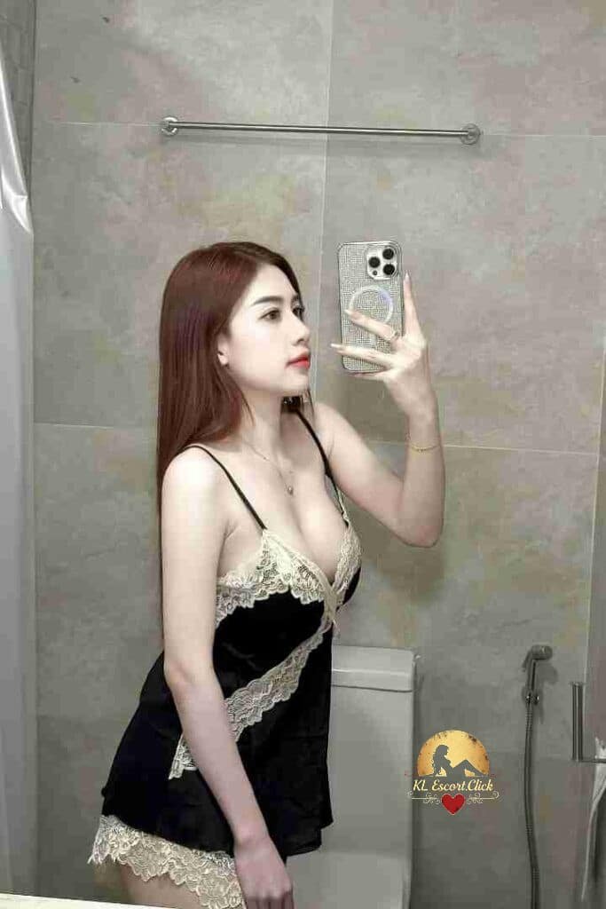Woman in black lingerie taking a selfie in a bathroom with a smartphone.