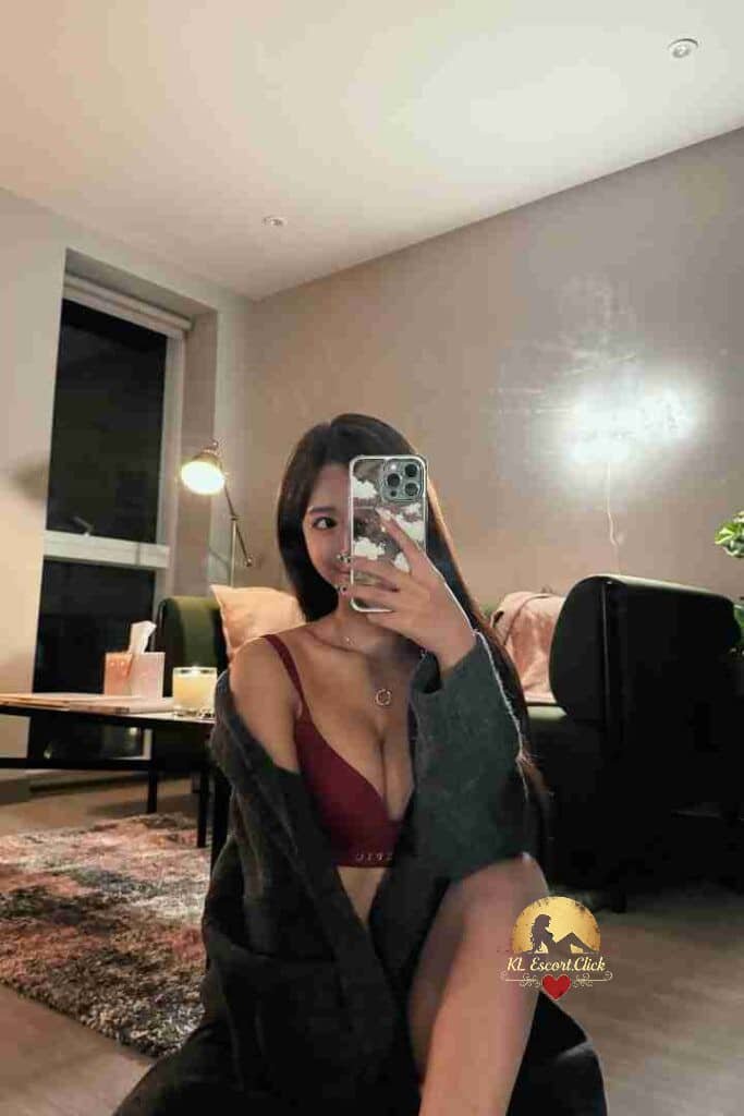 Woman in bra taking selfie indoors, cozy home setting.